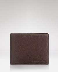 Carry your everyday essentials in a distinct pebbled leather wallet from Longchamp for a touch of modern luxury. Carry your everyday essentials in a distinct pebbled leather wallet from Longchamp for a touch of modern luxury.