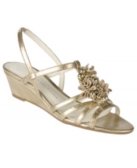 Offering pure elegance with floral detailing against a metallic backdrop, the Onna wedge sandals by Etienne Aigner present a lovely evening sandal for warmer nights. Offering pure elegance with floral detailing against a metallic backdrop, the Onna wedge sandals by Etienne Aigner present a lovely evening sandal for warmer nights.