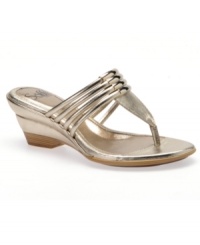 Eye-catching elegance. Shining metal accent highlight the beautiful straps of the Ivy wedge sandals by Sofft.