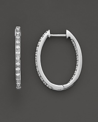 Elegant and simple oval inside-out hoop earrings crafted in 14k white gold and diamonds. Elegant and simple oval inside-out hoop earrings crafted in 14k white gold and diamonds.