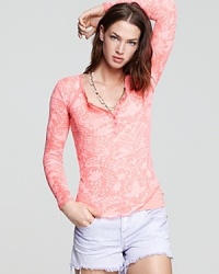 An ornate burnout design makes a subtle statement on this Free People henley top. An ornate burnout design makes a subtle statement on this Free People henley top.