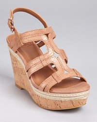 Subtly geometric in metallic leather, these shimmering sandals boast a cork wedge and stitched raffia trim at the midsole. From Lucky Brand. Subtly geometric in metallic leather, these shimmering sandals boast a cork wedge and stitched raffia trim at the midsole. From Lucky Brand.