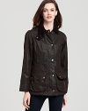 Barbour's medium-weight waxed cotton jacket with cozy tartan liner keeps you warm, dry and impeccably stylish.