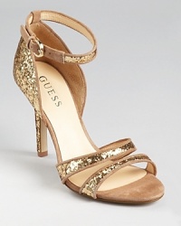 Sparkling glitter is trimmed in soft suede on the GUESS Laren sandals, a glimmering, trend-right style ideal for the chicest of soireés. Sparkling glitter is trimmed in soft suede on the GUESS Laren sandals, a glimmering, trend-right style ideal for the chicest of soireés.