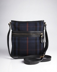 This crossbody messenger bag by Burberry is sure to be your go-to. Stash your tablet, work materials and more in this sleek carry-all, which looks as great as it performs. This crossbody messenger bag by Burberry is sure to be your go-to. Stash your tablet, work materials and more in this sleek carry-all, which looks as great as it performs.