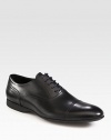 Gleaming Italian leather oxfords classically styled with intricate stitching and a lace-up front. Leather upperLeather liningPadded insoleRubber soleMade in Italy
