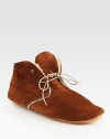 Cozy shearling lines this ultra-comfortable suede design with a rubber sole for added traction. Suede upperShearling liningRubber solePadded insoleMade in Italy