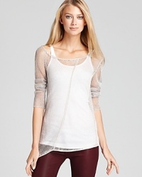 Crafted from a featherweight open knit metallic fabric, this provocative Chaser top features an edgy asymmetric hem--play up this fun-to-wear layer with a colorful cami or stay in neutral. Crafted from a featherweight open knit metallic fabric, this provocative Chaser top features an edgy asymmetric hem--play up this fun-to-wear layer with a colorful cami or stay in neutral.