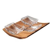 With its gorgeous materials and artistic design, the Wedge condiment bowl set gives pride of place to the ingredients that transform a meal from good to gourmet. Created by designer Neil Cohen, the set features a beautifully grained acacia wood base, carved with supple curved sides and shallow interior notches. Three brilliant full-lead crystal bowls rest against the notches for a charming zigzag display that calls out the colors of both wood and food. A lovely piece for the table or buffet, the set is perfect for fresh berries and whipped cream for a fancy brunch or cherry tomatoes and grated Parmesan for a simple pasta dinner. With its versatile uses and universally appealing aesthetics, the set makes an ideal bridal, hostess, or housewarming gift. With its gorgeous materials and artistic design, the Wedge condiment bowl set gives pride of place to the ingredients that transform a meal from good to gourmet. Created by designer Neil Cohen, the set features a beautifully grained acacia wood base, carved with supple curved sides and shallow interior notches. Three brilliant full-lead crystal bowls rest against the notches for a charming zigzag display that calls out the colors of both wood and food. A lovely piece for the table or buffet, the set is perfect for fresh berries and whipped cream for a fancy brunch or cherry tomatoes and grated Parmesan for a simple pasta dinner. With its versatile uses and universally appealing aesthetics, the set makes an ideal bridal, hostess, or housewarming gift.