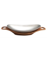 Strike a modern balance at your table with the Cradle serving bowl from Nambe's collection of serveware and serving dishes. Polished metal nests in a tray of sculpted wood, bringing the best of both materials to sleek, sophisticated decor. An elongated shape with built-in handles accommodates large entrees with ease and style. Strike a modern balance at your table with the Cradle serving bowl from Nambe's collection of serveware and serving dishes. Polished metal nests in a tray of sculpted wood, bringing the best of both materials to sleek, sophisticated decor. An elongated shape with built-in handles accommodates large entrees with ease and style.