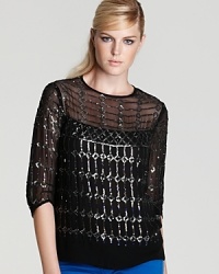 Sequins glitter in a intricate design sure to catch the light (and eyes) on this slouchy top from Nanette Lepore. Sequins glitter in a intricate design sure to catch the light (and eyes) on this slouchy top from Nanette Lepore.