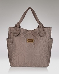 Casual, crinkled nylon, knotted handles and a sleek shape make this go-anywhere bag from Marc by Marc Jacobs the perfect weekend carry-all. Casual, crinkled nylon, knotted handles and a sleek shape make this go-anywhere bag from Marc by Marc Jacobs the perfect weekend carry-all.