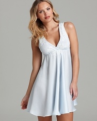 A flowy sleeveless chemise with lace detail along a surplice neckline. A flowy sleeveless chemise with lace detail along a surplice neckline.