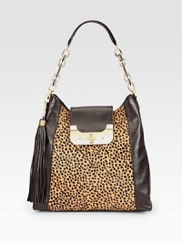 A beautiful leopard print hair calf panel with supple leather sides in a roomy carryall design.Leather and chain shoulder strap, 9 dropTurnlock strap closureDetachable tassel accentTwo outside open pockets, one under strap and one on backOne inside zip pocketTwo inside open pocketsOne pen holderFully lined13W X 12¾H X 4DImported