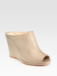 Leather slide wedge design with peep toe and slight platform. Self-covered wedge, 3¾ (95mm)Covered platform, ½ (15mm)Compares to a 3¼ heel (80mm)Leather upperPeep toeLeather liningRubber solePadded insoleImported Leather slide wedge design with peep toe and slight platform. Self-covered wedge, 3¾ (95mm)Covered platform, ½ (15mm)Compares to a 3¼ heel (80mm)Leather upperPeep toeLeather liningRubber solePadded insoleImported