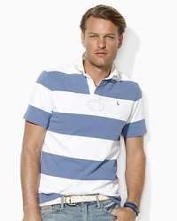 A short-sleeved rugby shirt is cut for a comfortable, relaxed fit from rustic utility cotton jersey with bold stripes for masculine polish. A short-sleeved rugby shirt is cut for a comfortable, relaxed fit from rustic utility cotton jersey with bold stripes for masculine polish.