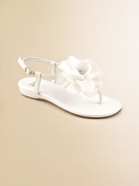 A graceful satin T strap blooms with a floppy flower of chiffon and tulle with a rhinestone center.Terylene satin upperT strap thong with flowerBuckle ankle strapFaux leather sole with rubber insertPadded insoleFaux leather liningImported A graceful satin T strap blooms with a floppy flower of chiffon and tulle with a rhinestone center.Terylene satin upperT strap thong with flowerBuckle ankle strapFaux leather sole with rubber insertPadded insoleFaux leather liningImported