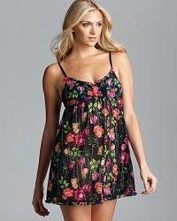 Go for girlishness in this floral print chiffon slip with contrast rosette appliqués along neckline and ruffle trim. Go for girlishness in this floral print chiffon slip with contrast rosette appliqués along neckline and ruffle trim.