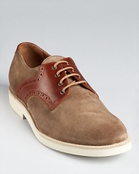 Saddle up your style with these classic, trend-right oxfords, featuring perforated leather detail and a soft suede upper. Saddle up your style with these classic, trend-right oxfords, featuring perforated leather detail and a soft suede upper.