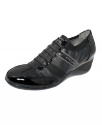 Casually chic. DKNY Active's Piri wedge sneakers will finish your look with some shine--and a little bit of height. Casually chic. DKNY Active's Piri wedge sneakers will finish your look with some shine--and a little bit of height.