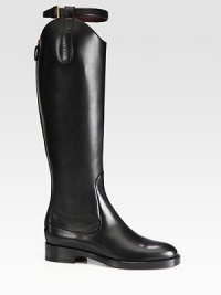 An equestrian-inspired bridle buckle tops this asymmetrical leather silhouette resting on a stacked heel. Stacked heel, 1¼ (30mm)Shaft, 17¼Leg circumference, 13Leather upperBack zip and adjustable leather strapLeather lining and solePadded insoleMade in ItalyThis style runs true to size. We recommend ordering your usual size for a standard fit. An equestrian-inspired bridle buckle tops this asymmetrical leather silhouette resting on a stacked heel. Stacked heel, 1¼ (30mm)Shaft, 17¼Leg circumference, 13Leather upperBack zip and adjustable leather strapLeather lining and solePadded insoleMade in ItalyThis style runs true to size. We recommend ordering your usual size for a standard fit.