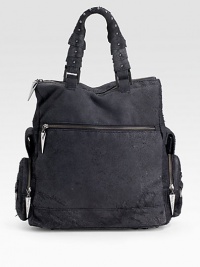 A capacious design in sumptuous leather has edgy metal hardware and a rock-chic aesthetic.Studded wrapped leather top handles, 5 drop Wrapped leather shoulder strap, 12 drop Top zip closure Four outside zip pockets Protective metal feet One inside zip pocket Three inside open pockets Fully lined 15W X 14H X 5D Imported A capacious design in sumptuous leather has edgy metal hardware and a rock-chic aesthetic.Studded wrapped leather top handles, 5 drop Wrapped leather shoulder strap, 12 drop Top zip closure Four outside zip pockets Protective metal feet One inside zip pocket Three inside open pockets Fully lined 15W X 14H X 5D Imported