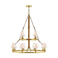 Elegantly rendered in luxurious saddle leather and brass, this modern Ralph Lauren chandelier illuminates through twelve bulbs topped with textural linen shades.