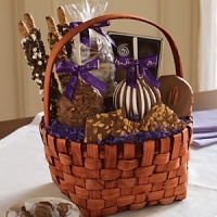 An assortment of classic treats. Includes: one Triple Chocolate petite apple, one Milk Chocolate Walnut petite apple, two caramel-dipped pretzels, 1/4 lb. of Milk Chocolate Almond Bark, a 4.5-oz. bag of Classic Vanilla caramels, and one Milk Chocolate Pecan nut cluster. The deluxe version contains an additional 4-Piece Truffle sampler and two additional caramel-dipped pretzels. An assortment of classic treats. Includes: one Triple Chocolate petite apple, one Milk Chocolate Walnut petite apple, two caramel-dipped pretzels, 1/4 lb. of Milk Chocolate Almond Bark, a 4.5-oz. bag of Classic Vanilla caramels, and one Milk Chocolate Pecan nut cluster. The deluxe version contains an additional 4-Piece Truffle sampler and two additional caramel-dipped pretzels.