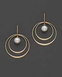 Beautiful textures in 14 Kt. yellow gold. A double hoop earring with fresh water pearl center. Beautiful textures in 14 Kt. yellow gold. A double hoop earring with fresh water pearl center.