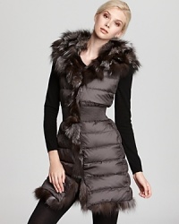 Flaunt fabulous style as the degrees drop with this oh-so-luxe fur-trimmed down vest from Dawn Levy. Flaunt fabulous style as the degrees drop with this oh-so-luxe fur-trimmed down vest from Dawn Levy.
