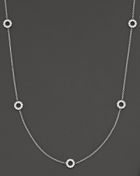 A delicate white gold chain with 5 double-sided white gold diamond circle stations. A delicate white gold chain with 5 double-sided white gold diamond circle stations.