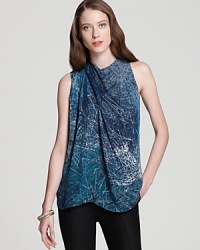 Etched with an abstract print and finished with an asymmetrical silhouette, this Halston Heritage blouse is the ultimate in urban cool. Juxtapose the silky style with a structured leather jacket and spark some serious fashion envy. Etched with an abstract print and finished with an asymmetrical silhouette, this Halston Heritage blouse is the ultimate in urban cool. Juxtapose the silky style with a structured leather jacket and spark some serious fashion envy.