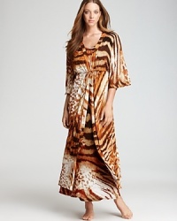 An abstract mix of tiger stripes and leopard spots covers this Natori robe, featuring ruffle trim at the waist. An abstract mix of tiger stripes and leopard spots covers this Natori robe, featuring ruffle trim at the waist.