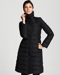 With a pure grey goose down fill, this Armani Collezioni essential down coat is a must in an iconically quilted, A-line silhouette. With a pure grey goose down fill, this Armani Collezioni essential down coat is a must in an iconically quilted, A-line silhouette.
