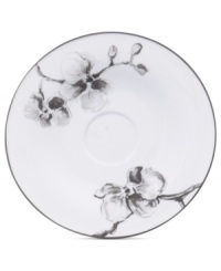 Compose a striking arrangement with the Black Orchid saucer by Michael Aram. Fine white Limoges porcelain flourishes under a dark watercolor motif inspired by foliage from around the world. Compose a striking arrangement with the Black Orchid saucer by Michael Aram. Fine white Limoges porcelain flourishes under a dark watercolor motif inspired by foliage from around the world.