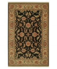 Inspired by the lush tapestries of the 17th-century Mogul dynasty, this classic rug features a scrolling vine design of oversized palmettes and serrated leaves. Green and ivory colors complement the deep shade of a black ground. Woven of premium worsted New Zealand wool. Inspired by the lush tapestries of the 17th-century Mogul dynasty, this classic rug features a scrolling vine design of oversized palmettes and serrated leaves. Green and ivory colors complement the deep shade of a black ground. Woven of premium worsted New Zealand wool.