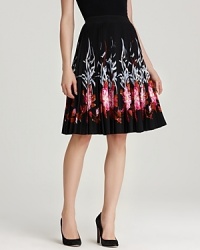 Bold florals blossom alongside the fluttering hemline of this pleated DKNY skirt. Pair with black pumps and a fitted blouse for classic feminine appeal. Bold florals blossom alongside the fluttering hemline of this pleated DKNY skirt. Pair with black pumps and a fitted blouse for classic feminine appeal.