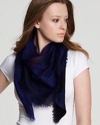 Wrap yourself in style with a sheer woven wool scarf featuring Burberry's iconic check pattern in a deep blue hue. Wrap yourself in style with a sheer woven wool scarf featuring Burberry's iconic check pattern in a deep blue hue.