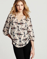 A crossover neckline, chic shirring and on-trend tribal print give this Aqua shirt all the style it needs to be called must have this season. Perfect for your work-to-weekend wardrobe, it pairs with ankle pants perfectly, then complements your distressed skinnies with finesse. A crossover neckline, chic shirring and on-trend tribal print give this Aqua shirt all the style it needs to be called must have this season. Perfect for your work-to-weekend wardrobe, it pairs with ankle pants perfectly, then complements your distressed skinnies with finesse.