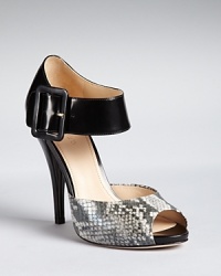 Snake-embossed peep toes add sensual appeal to sky high Joan & David Sandals. Platforms and bold, broad ankle straps make them ultra wearable. Snake-embossed peep toes add sensual appeal to sky high Joan & David Sandals. Platforms and bold, broad ankle straps make them ultra wearable.