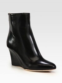 Achieve sleek and sophisticated style with this polished leather essential resting atop an elevated wedge. Self-covered wedge, 3½ (90mm)Leather upperBack zipLeather liningLeather and rubber solePadded insoleMade in Italy Achieve sleek and sophisticated style with this polished leather essential resting atop an elevated wedge. Self-covered wedge, 3½ (90mm)Leather upperBack zipLeather liningLeather and rubber solePadded insoleMade in Italy