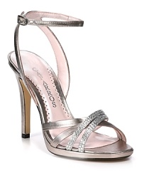 Rhinestone-strewn straps streak like sparkling comets across Caparros' elegant evening sandals. Rhinestone-strewn straps streak like sparkling comets across Caparros' elegant evening sandals.