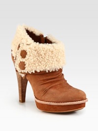 Cozy shearling defines this suede platform silhouette with a towering stacked heel, side zip and covered buttons. Stacked heel, 4¾ (120mm)Suede platform, 1 (25mm)Compares to a 3¾ heel (95mm)Suede upper with foldover shearling liningSide buttons and side zipShearling liningLeather and rubber solePadded insoleImported