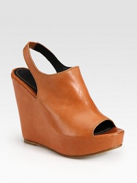 Sleek leather slide has a secure, stretchy slingback and a chunky wedge. Self-covered wedge, 4½ (115mm)Covered platform, 1 (25mm)Compares to a 3½ heel (90mm)Leather upperLeather lining and solePadded insoleImportedOUR FIT MODEL RECOMMENDS ordering one size up as this style runs small. Sleek leather slide has a secure, stretchy slingback and a chunky wedge. Self-covered wedge, 4½ (115mm)Covered platform, 1 (25mm)Compares to a 3½ heel (90mm)Leather upperLeather lining and solePadded insoleImportedOUR FIT MODEL RECOMMENDS ordering one size up as this style runs small.