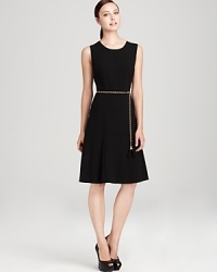 A modern update to the classic LBD, this Calvin Klein dress touts a flared skirt topped with a gold-tone belt for a curve-enhancing silhouette guaranteed to shine. A modern update to the classic LBD, this Calvin Klein dress touts a flared skirt topped with a gold-tone belt for a curve-enhancing silhouette guaranteed to shine.