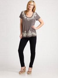 Pretty embroidery adorns the front and back of this cotton tee. The flattering scoopneck and elongated silhouette will flawlessly complement your curves.ScoopneckShort sleevesAbout 29 from shoulder to hemCottonMachine washImported