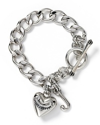 Silvertone chain charm bracelet with toggle closure. Iconic heart with Juicy script J charm.