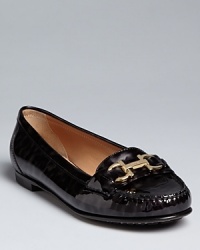 Salvatore Ferragamo makes these loafers shine in gleaming patent and gold-tone hardware. Salvatore Ferragamo makes these loafers shine in gleaming patent and gold-tone hardware.