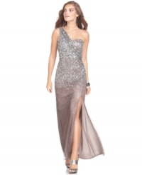 Xscape's gown glitters with a cascade of sequins on a one-shoulder silhouette. Xscape's gown glitters with a cascade of sequins on a one-shoulder silhouette.