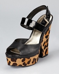 With a leopard printed heel and platform, these GUESS sandals make a slick statement for day or night. With a leopard printed heel and platform, these GUESS sandals make a slick statement for day or night.